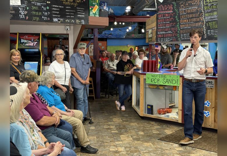 Rob Sand speaks to residents at town hall hosted at Borderline Pizza in Forest City